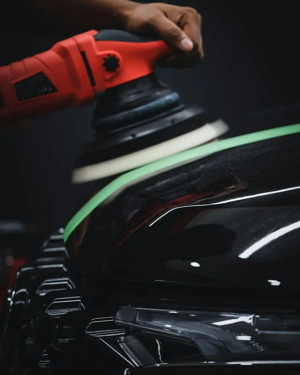 Machine polishing a black car