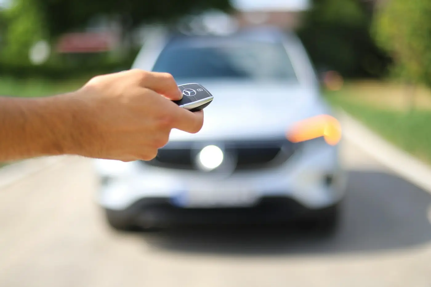 Car key handed over in front of a rental SUV